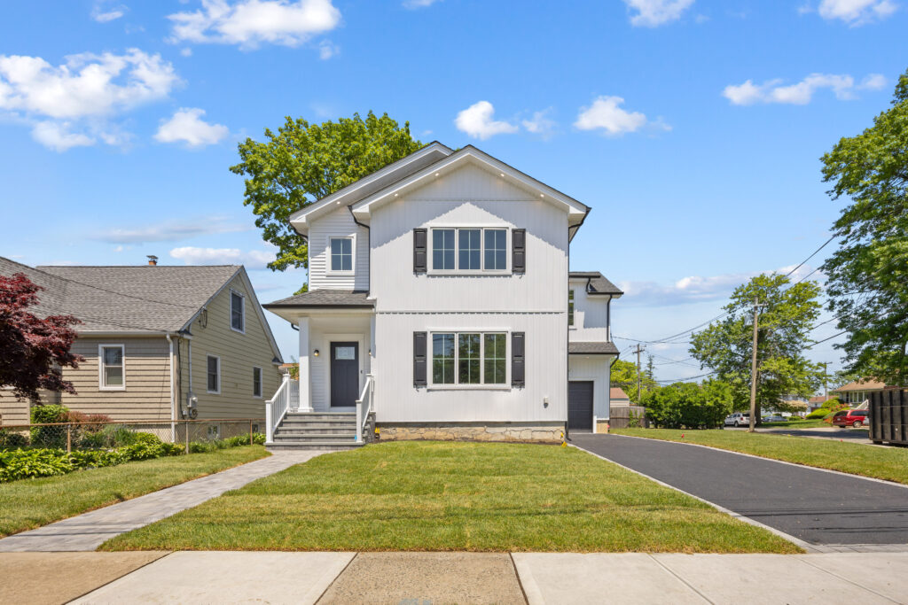 replacement windows long beach ny installed on a modern white home with new trim and energy-efficient glass