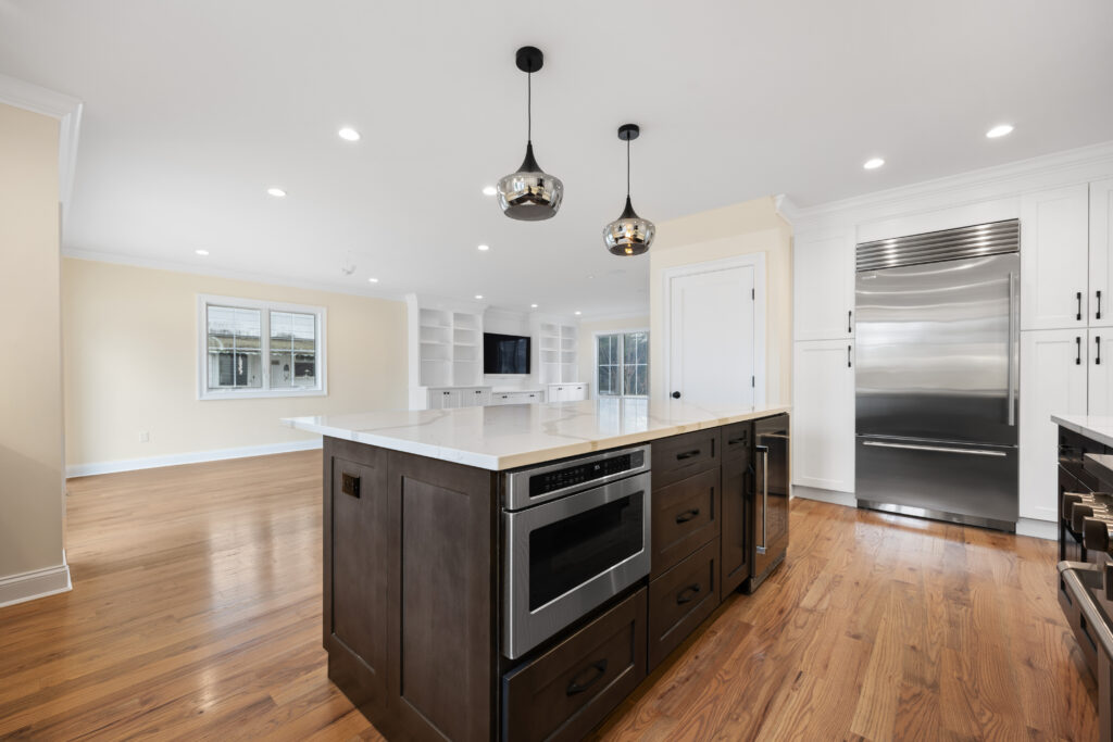 Bright kitchen remodel with white cabinets and stainless steel appliances in Long Beach NY