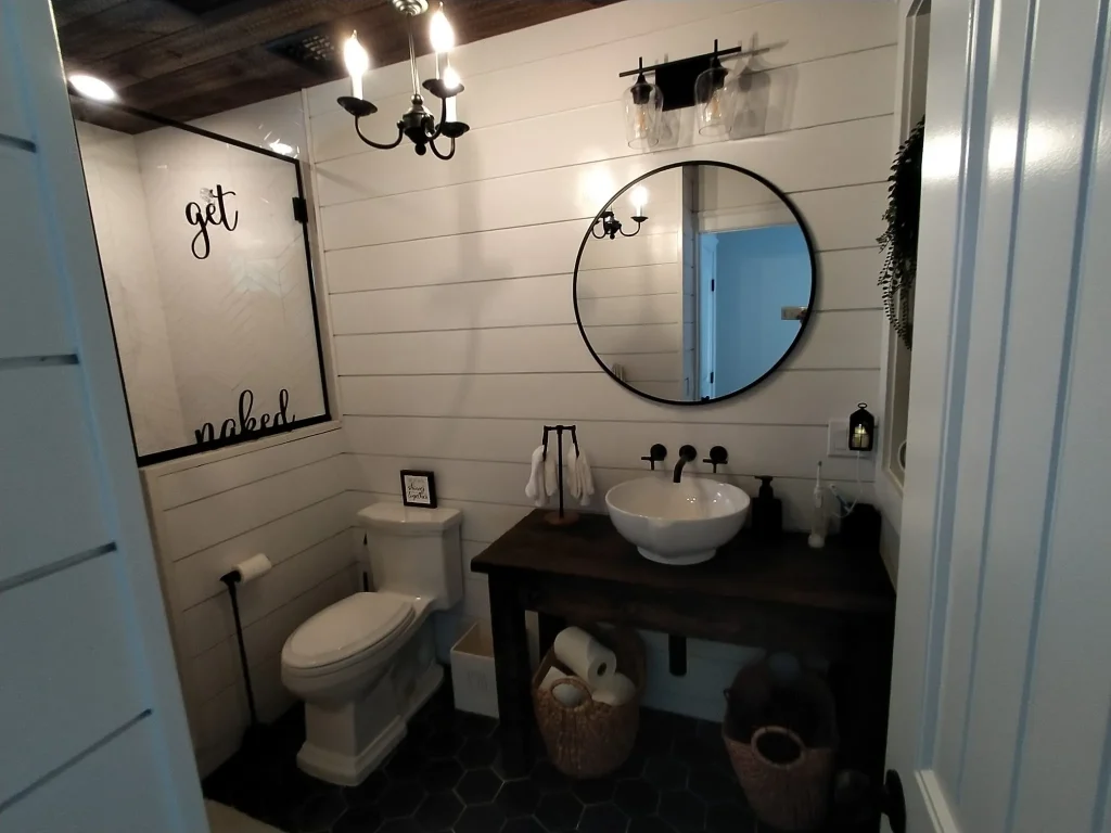 High-end dark themed bathroom with gold accents and circular mirrors - remodel bathroom Long Beach