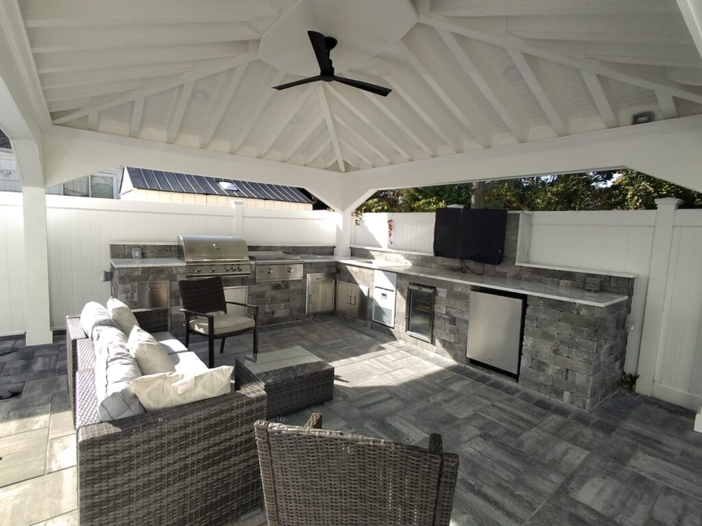 Spacious covered patio with kitchen and seating remodeled in Long Beach NY