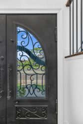 Long Beach contractor-installed ornamental steel entry door with detailed scrollwork